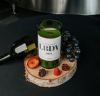 Bougie Merlot LBDV – Format bouteille sur rondelle de bois avec fruits noirs